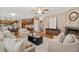 Open-concept living room with hardwood floors seamlessly connects to the kitchen and dining area at 13744 W 86Th Dr, Arvada, CO 80005
