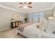 Bedroom with a ceiling fan, modern decor, and large windows allowing ample natural light at 13744 W 86Th Dr, Arvada, CO 80005