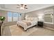 Bedroom featuring a ceiling fan, neutral color palette, and large windows allowing ample natural light at 13744 W 86Th Dr, Arvada, CO 80005