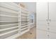 Walk-in closet featuring abundant shelving and storage options, offering an organized space for clothing and accessories at 13744 W 86Th Dr, Arvada, CO 80005
