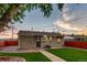 Backyard featuring green lawn, stone walkway, privacy fence, and professional landscaping at 488 S Leyden St, Denver, CO 80224