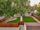 Aerial view of backyard featuring lush green lawn, mature trees, and privacy fence at 488 S Leyden St, Denver, CO 80224