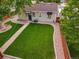 Aerial view of backyard featuring lush green lawn, a stone walkway, and wood perimeter fence at 488 S Leyden St, Denver, CO 80224