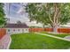 The backyard is landscaped with lush green grass, a privacy fence and a detached garage at 488 S Leyden St, Denver, CO 80224
