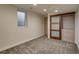 Basement room featuring a window, closet with sliding doors, built-in drawers and neutral carpet at 488 S Leyden St, Denver, CO 80224