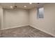 Finished basement with neutral walls, plush carpet, and a window for natural light at 488 S Leyden St, Denver, CO 80224
