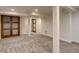 Finished basement with carpeted floors and wood accent door at 488 S Leyden St, Denver, CO 80224