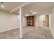 Finished basement with carpeted floors and wood accent door at 488 S Leyden St, Denver, CO 80224