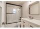 The bathroom features a glass enclosed shower, toilet, and vanity with modern fixtures and ample storage at 488 S Leyden St, Denver, CO 80224