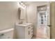 Cozy bathroom showcases a white vanity, stylish mirror, and a convenient toilet, perfect for everyday use at 488 S Leyden St, Denver, CO 80224