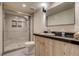 Modern bathroom featuring a glass shower and vessel sink on black countertop at 488 S Leyden St, Denver, CO 80224