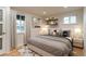 Bedroom with hardwood floors, neutral decor and soft natural light from two windows at 488 S Leyden St, Denver, CO 80224