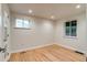 Bright bedroom features hardwood floors, recessed lighting, and two windows at 488 S Leyden St, Denver, CO 80224
