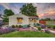Charming brick home featuring professional landscaping with colorful flowers and mature trees at 488 S Leyden St, Denver, CO 80224