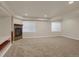 Spacious basement Gathering room with fireplace and built-in shelving at 21719 E Tallkid Ave, Parker, CO 80138