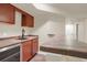 Wet bar with tile countertop, sink and mini-fridge at 21719 E Tallkid Ave, Parker, CO 80138