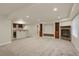 Spacious basement Gathering room with fireplace and built-in shelving at 21719 E Tallkid Ave, Parker, CO 80138