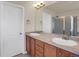 Double vanity bathroom with wood cabinets and a large mirror at 21719 E Tallkid Ave, Parker, CO 80138