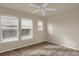 Well-lit bedroom featuring two windows and a ceiling fan at 21719 E Tallkid Ave, Parker, CO 80138