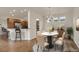 Bright dining room features a round table with seating for six and hardwood floors at 21719 E Tallkid Ave, Parker, CO 80138