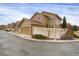 Tan two-story house with attached garage and white fence at 21719 E Tallkid Ave, Parker, CO 80138