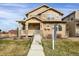 Two-story Craftsman home with stone accents and a welcoming porch at 21719 E Tallkid Ave, Parker, CO 80138