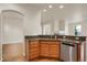 Kitchen with granite countertops, stainless steel appliances, and wood cabinets at 21719 E Tallkid Ave, Parker, CO 80138