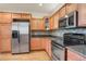 Modern kitchen featuring stainless steel appliances and wood cabinets at 21719 E Tallkid Ave, Parker, CO 80138