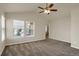 Main bedroom with carpet, ceiling fan and access to bathroom at 21719 E Tallkid Ave, Parker, CO 80138