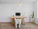 Contemporary home office setup with a minimalist desk, modern chair, and vibrant cactus plants at 891 14Th St # 1211, Denver, CO 80202