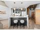 Modern kitchen with stainless steel appliances, island with counter seating, and pendant lighting at 891 14Th St # 1211, Denver, CO 80202