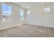 Spacious bedroom with ample natural light from multiple windows, neutral carpet, and freshly painted walls at 2128 S Haleyville Way, Aurora, CO 80018