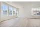 Bright living room with plenty of natural light, with windows and a light wood floor at 2128 S Haleyville Way, Aurora, CO 80018