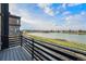 Balcony overlooking a tranquil lake and surrounding landscape at 2321 Lakeshore Ln # 10, Superior, CO 80027