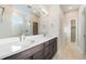 Bathroom featuring double sinks, a shower with glass door, and modern lighting with neutral paint at 2321 Lakeshore Ln # 10, Superior, CO 80027