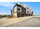 Exterior of modern townhome with attached garages, stone and black trim at 2321 Lakeshore Ln # 10, Superior, CO 80027