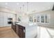 Modern kitchen island with a white countertop, dark cabinets, and pendant lighting at 2321 Lakeshore Ln # 10, Superior, CO 80027