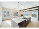 Bright, modern kitchen with a large island, stylish pendant lights, and a view of the fireplace and the lake at 2321 Lakeshore Ln # 10, Superior, CO 80027