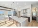 Open kitchen with a large island, stainless steel appliances and hardwood floors throughout at 2321 Lakeshore Ln # 10, Superior, CO 80027