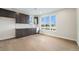 Bright kitchenette features dark cabinets, stainless steel appliances, and a window with a beautiful lake view at 2321 Lakeshore Ln # 10, Superior, CO 80027