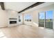 Spacious living room with a fireplace and a sliding glass door leading to a balcony with lake views at 2321 Lakeshore Ln # 10, Superior, CO 80027
