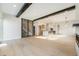 Open-concept living area with exposed wood beams, leading to the modern kitchen and dining area at 2321 Lakeshore Ln # 10, Superior, CO 80027