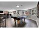 Finished basement with dark floors, bar with seating, and pool table, perfect for entertaining at 10822 Eagle Crest Ct, Parker, CO 80138