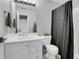 Well-lit bathroom with single sink and a shower with dark shower curtain at 10822 Eagle Crest Ct, Parker, CO 80138