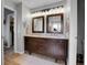 Bathroom featuring double vanity, granite countertops, wood floors, and modern lighting at 10822 Eagle Crest Ct, Parker, CO 80138