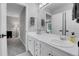Bathroom with double sinks, a large mirror, and views to an adjoining room at 10822 Eagle Crest Ct, Parker, CO 80138