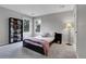 Cozy bedroom with a large window, carpet, decorative shelving, and a comfortable bed at 10822 Eagle Crest Ct, Parker, CO 80138