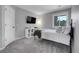 Comfortable bedroom with large window, carpet, mounted TV, and a decorative shelf at 10822 Eagle Crest Ct, Parker, CO 80138