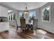 Charming dining room with hardwood floors, updated light fixture, and bright windows at 10822 Eagle Crest Ct, Parker, CO 80138