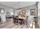 Spacious dining room with modern lighting and comfortable chairs, adjacent to living room at 10822 Eagle Crest Ct, Parker, CO 80138